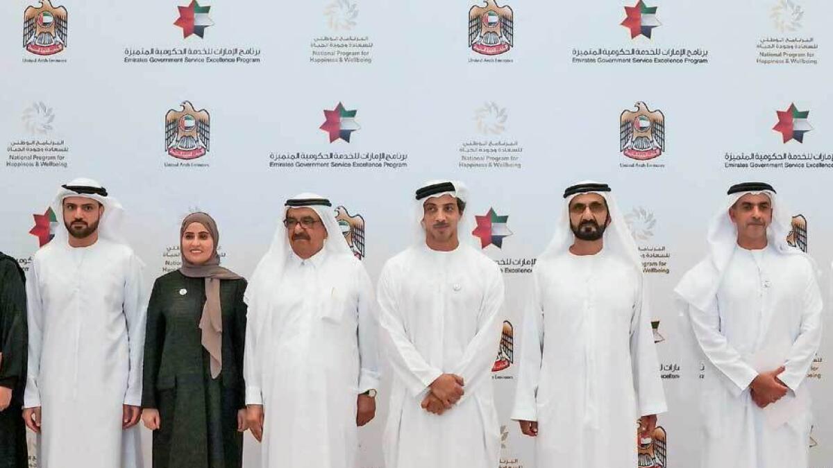 Sheikh Mohammed bin Rashid with the winners of the Happiness and Positivity Medal on Monday. — Wam
