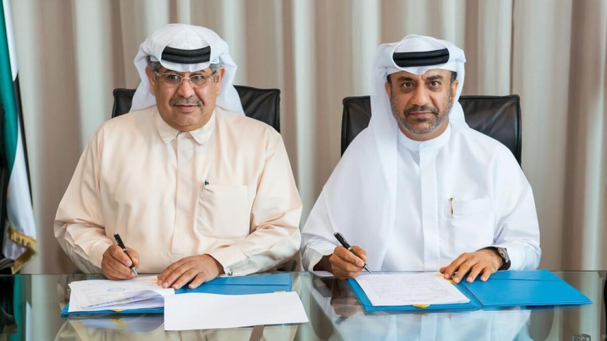 Yaseen Jaffer, CEO of Proclad, and Ibrahim Mohammed Al Janahi, deputy CEO and chief commercial officer of Economic Zones World, sign the agreement.