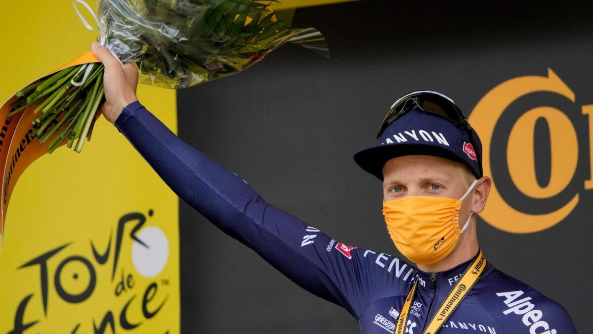 First-place Team Alpecin Fenix' Tim Merlier of Belgium celebrates on the podium after wining the 3rd stage of the 108th edition of the Tour de France cycling race. — AFP