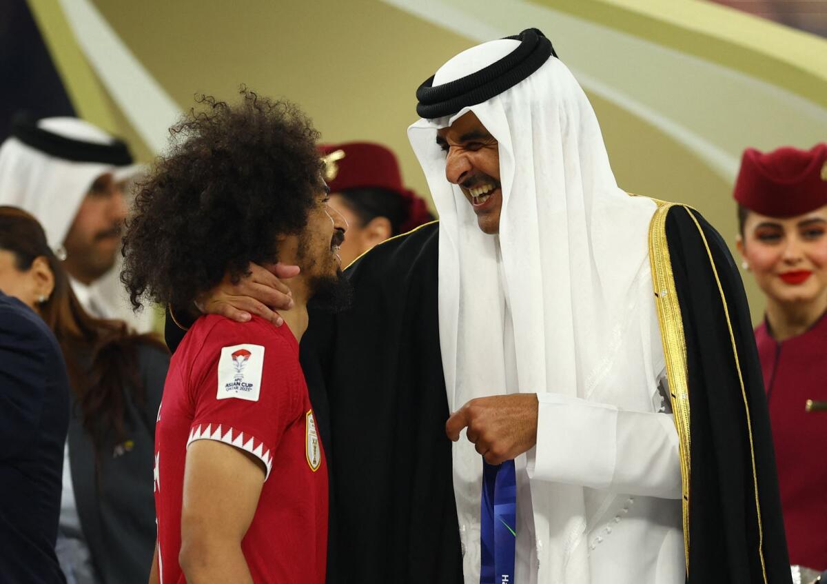 Qatari striker Akram Afif with Qatar's Emir, Sheikh Tamim bin Hamad Al-Thani after the Asian Cup final. — Reuters