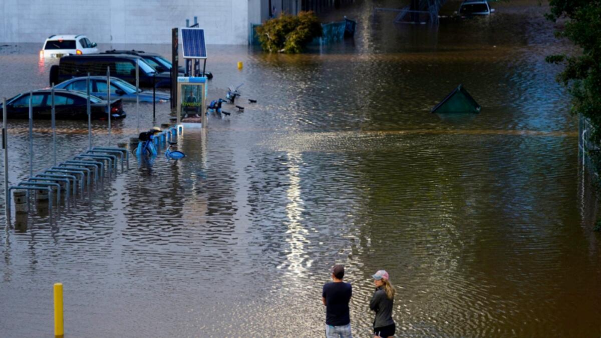 People view a flooded street in Philadelphia. — AP