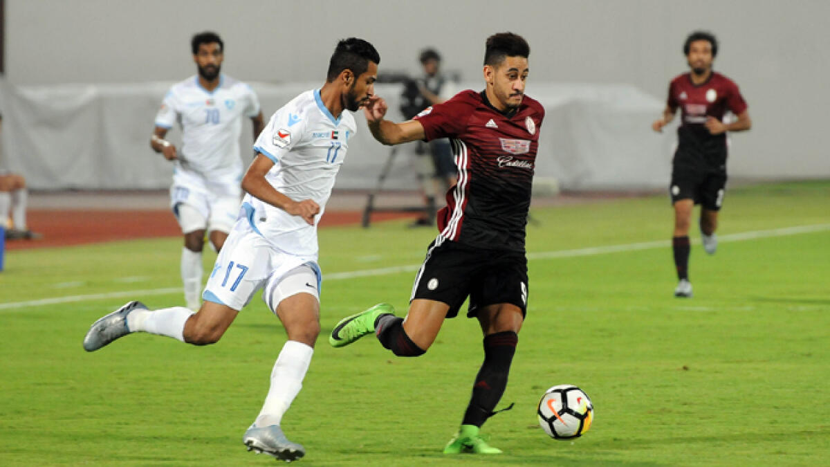 Al Wahda striker Mourad Batna and Hatta defender Sebil Ghazi in action during the Arabian Gulf League match at Al Nahyan Stadium in Abu Dhabi.- Supplied photo