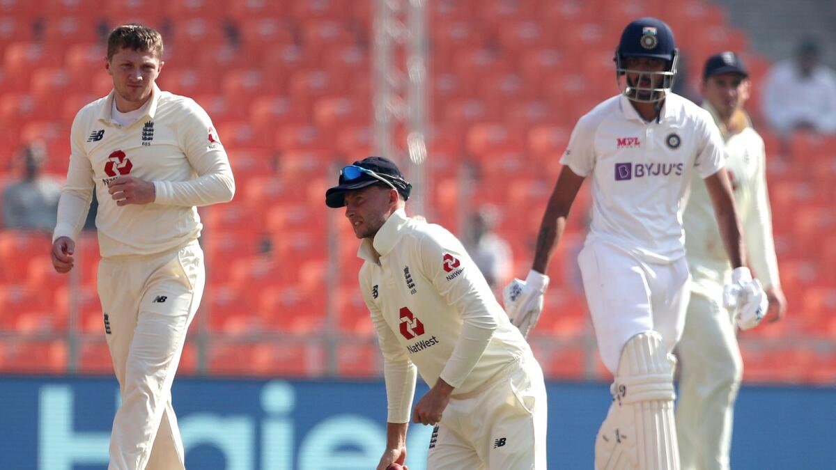 England's captain Joe Root (centre) reacts after fielding the ball during the third day of fourth Test in Ahmedabad. — AP