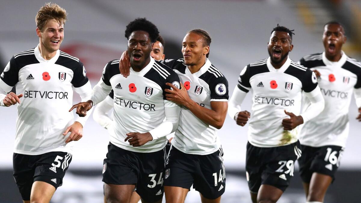 Fulham's Ola Aina celebrates scoring their second goal with teammates.