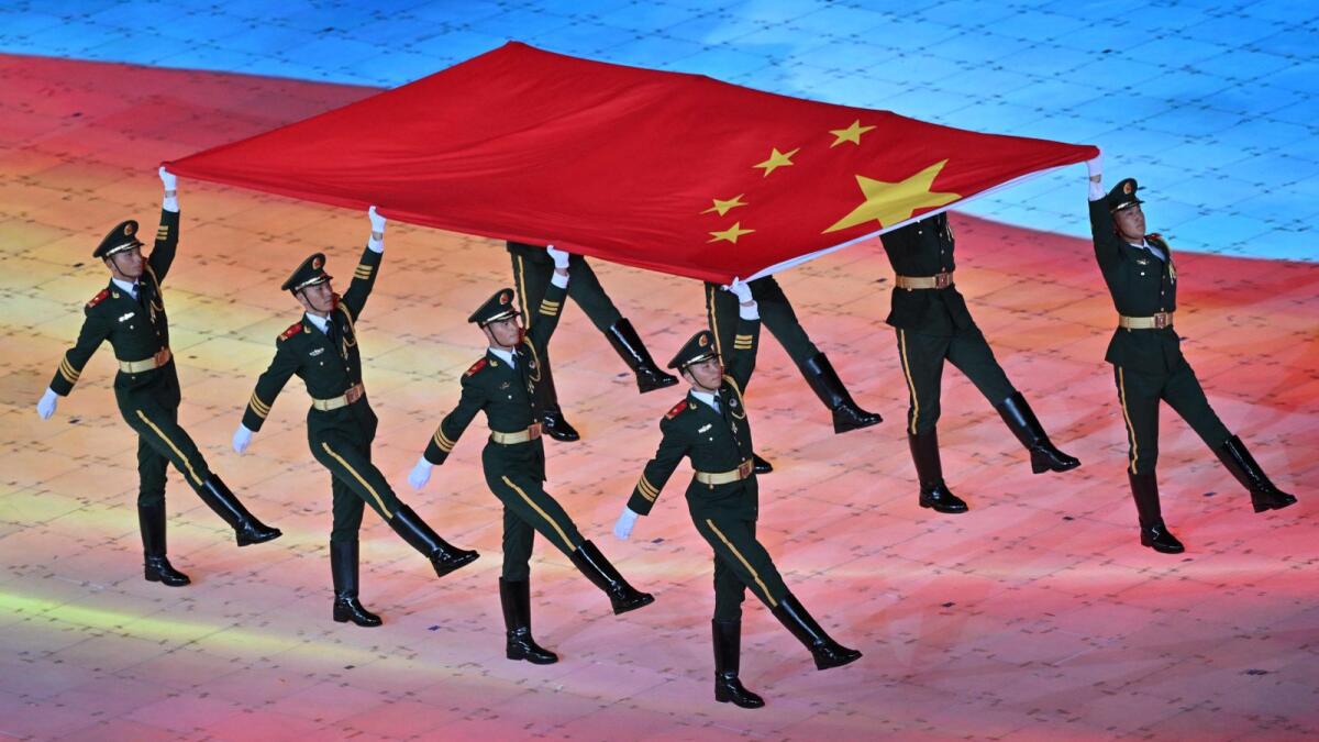 China's national flag is carried during the opening ceremony of the 2022 Asian Games. - AFP