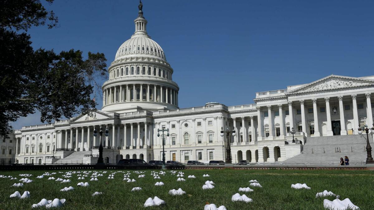 National Nurses United (NNU) display 164 white clogs shoes outside the US Capitol to honor the more than 160 nurses who have lost their lives from Covid-19 in the United States, and to demand the Senate act swiftly to protect nurses on the frontlines in Washington, DC. Photo: AFP