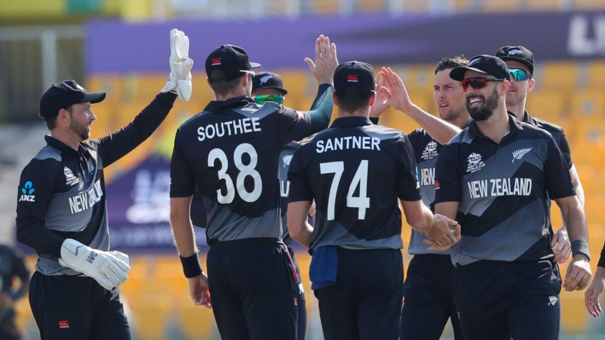New Zealand's Trent Boult (third from right) is congratulated by teammates after taking the wicket of Afghanistan's Hazratullah Zazai during the match in Abu Dhabi. (AP)