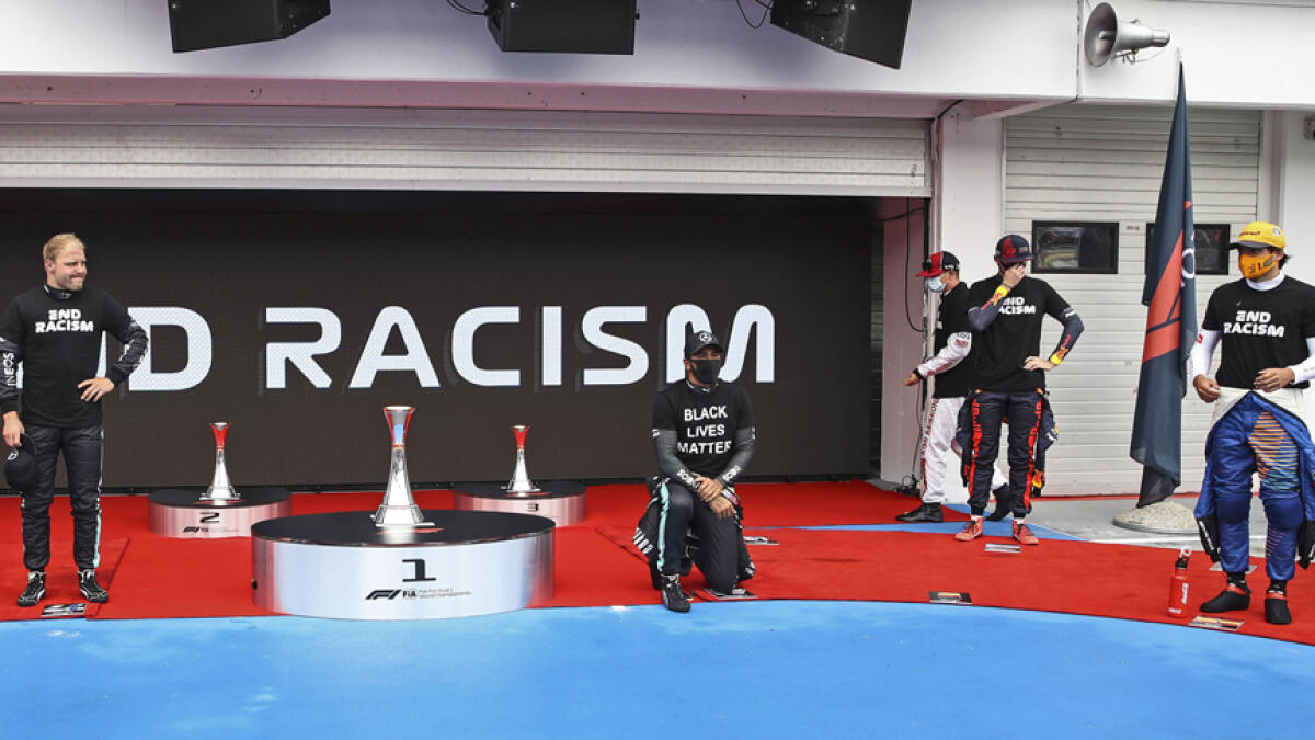 Mercedes driver Lewis Hamilton takes the knee beside the drivers prior the the Hungarian Formula One Grand Prix race on Sunday. - AP