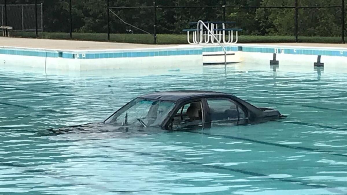 Photos: Car lands in swimming pool during driving lesson 