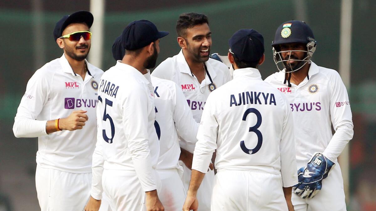 India's R Ashwin (second from right) celebrates the dismissal of New Zealand's Tom Latham on the fifth day of the first Test in Kanpur on Monday. — ANI