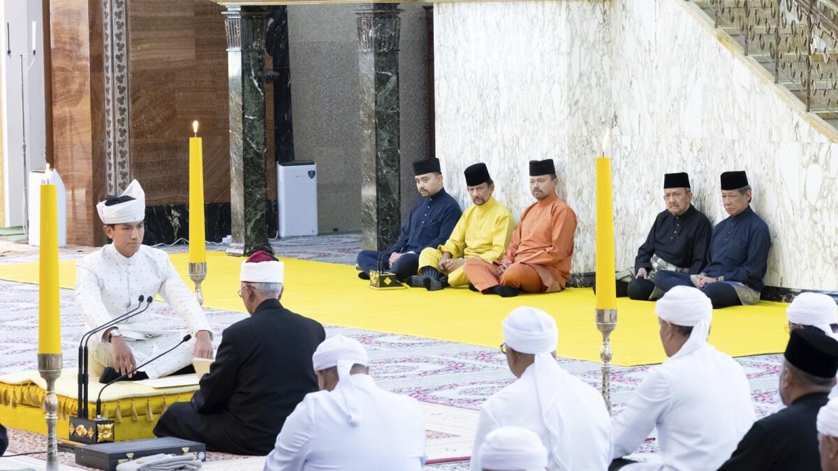 Brunei's Prince Abdul Mateen, left, sitting during his solemnization at Sultan Omar Ali Saifuddien Mosque in Bandar Seri Begawan, Brunei. — AP