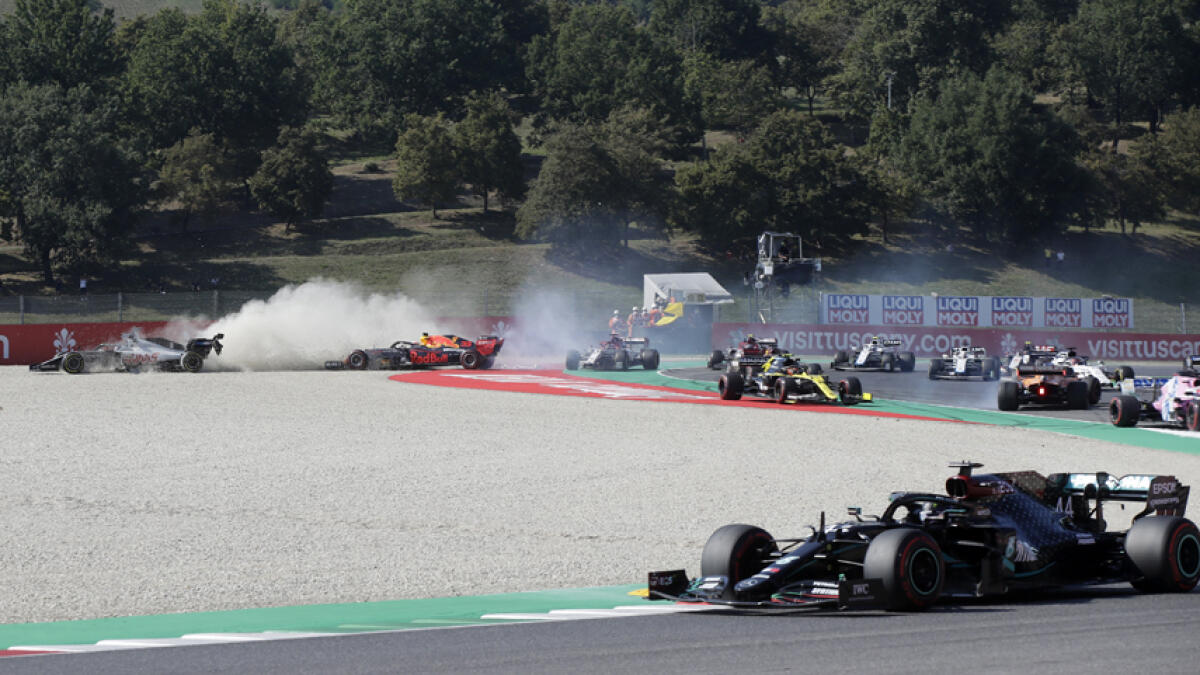 Haas' Romain Grosjean and Red Bull's Max Verstappen crash out at the start of the race. - Reuters
