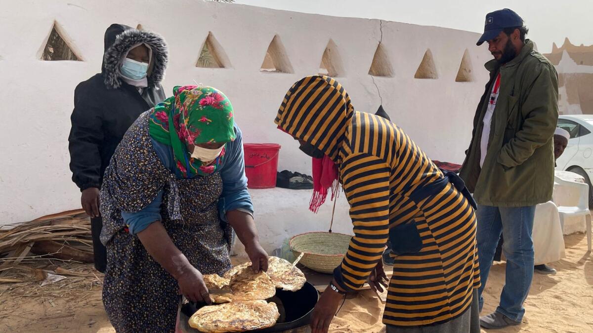 Libyan women bake flatbread near the Libyan town of Ghadames, a desert oasis some 650 kilometres  southwest of the capital Tripoli on February 3. — AFP