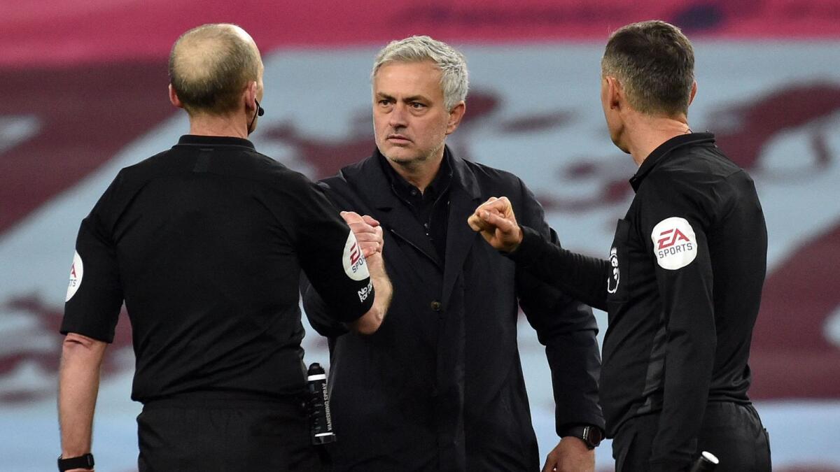 Jose Mourinho (centre) shakes hands with referee Mike Dean after the English Premier League match between Aston Villa and Tottenham Hotspur. — AFP