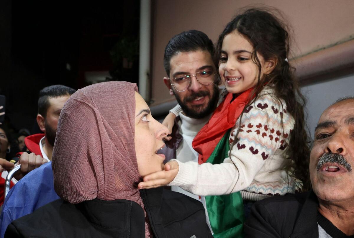 Fatima Shaheen' daughter Aylool gently caresses her mother's cheek after her release from an Israeli prison. AFP