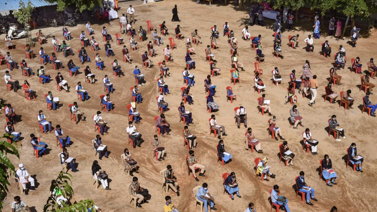 Students sit maintaining social distancing norms as they wait to appear in SSLC examinations at a centre in Bengaluru, India. Photo: PTI