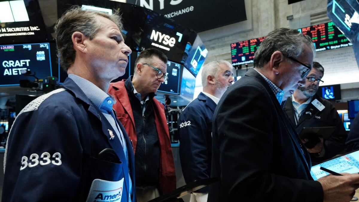 Traders work on the floor of the New York Stock Exchange. The bond issuance, presumably at the current high interest rates, is seen depleting banks’ reserves. — AFP