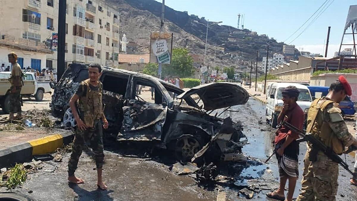 Yemeni security forces gather at the scene of a car bomb explosion in Aden, on Sunday. – AFP