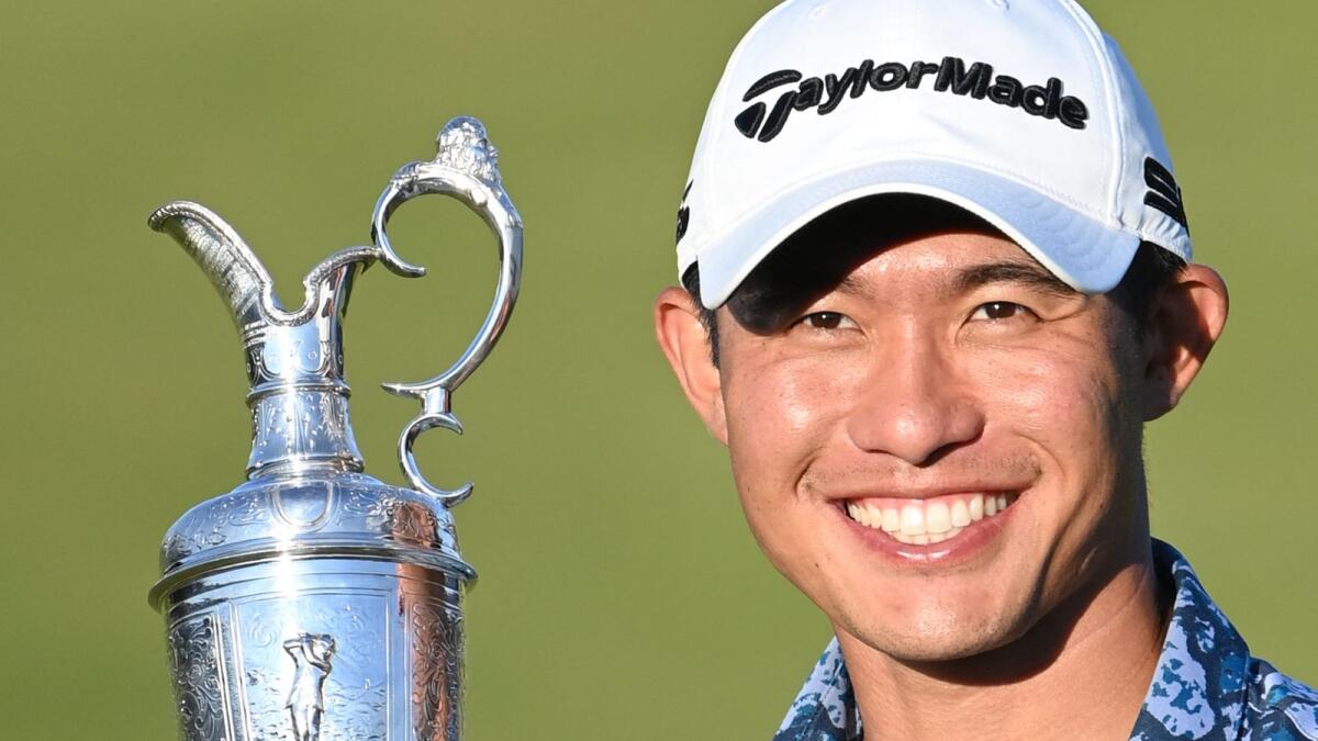 US golfer Collin Morikawa poses with the trophy after winning the British Open. (AFP)