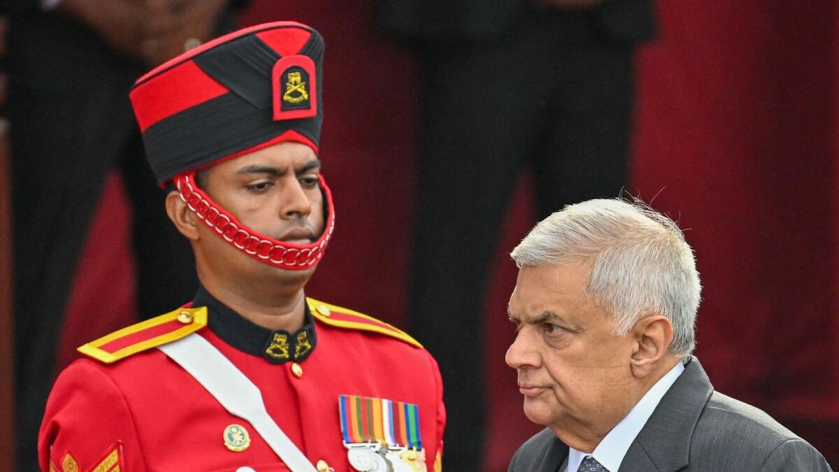 Sri Lanka's President Ranil Wickremesinghe (R) arrives for celebrations to mark the country's 75th anniversary of independence from Britain in Colombo on Saturday. -  AFP