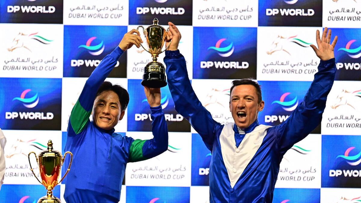 Jockeys Frankie Dettori and Yutaka Yoshida celebrate a photo finish win in the Dubai Turf. (Photo by Neeraj Murali)