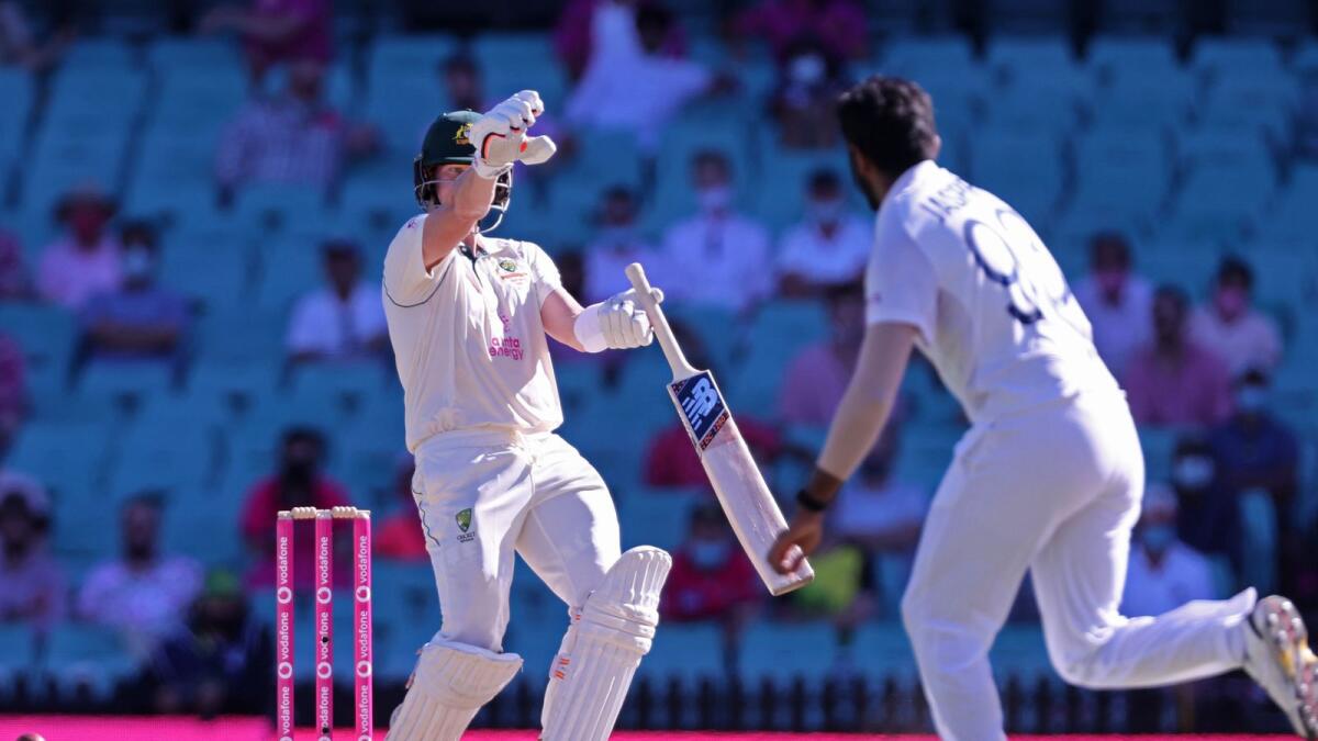 Australia's Steven Smith gestures after playing a shot as India's Jasprit Bumrah watches on the third day of the third cricket Test. — AFP