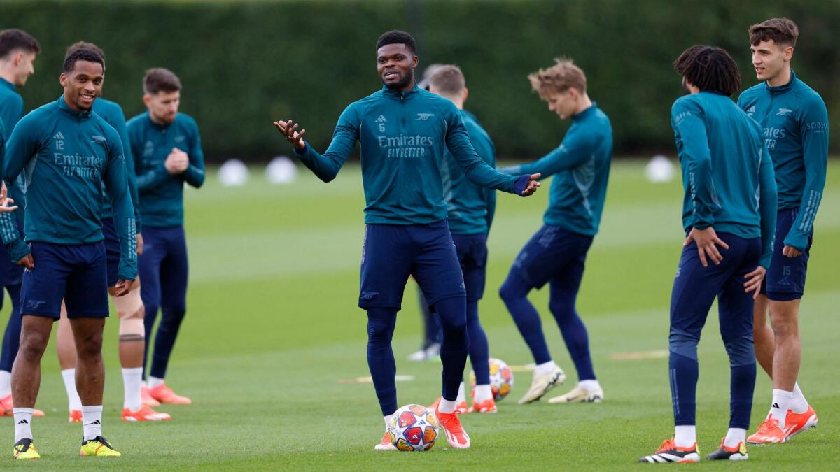 Arsenal's Thomas Partey with Jurrien Timber, Mohamed Elneny and teammates during training. - Reuters