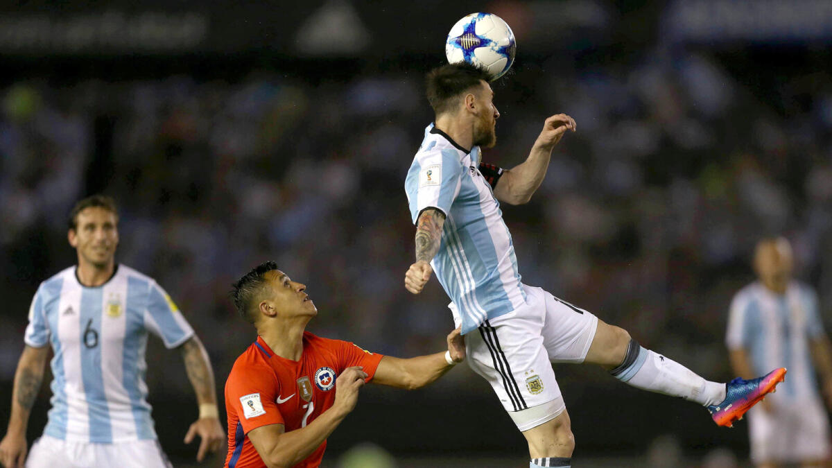 Football Soccer - Argentina v Chile - World Cup 2018 Qualifiers - Antonio Liberti Stadium, Buenos Aires, Argentina - 23/3/17 - Argentina's Lionel Messi (R) and Chile's Alexis Sanchez compete for the ball. REUTERS/Alberto Raggio EDITORIAL USE ONLY. NO RESALES. NO ARCHIVE