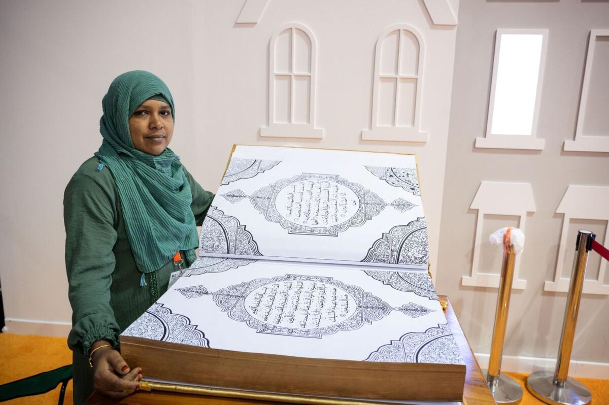 Jaleena with the Calligraphic handwritten Holy Quran at SIBF 2023. Photo: Suppllied