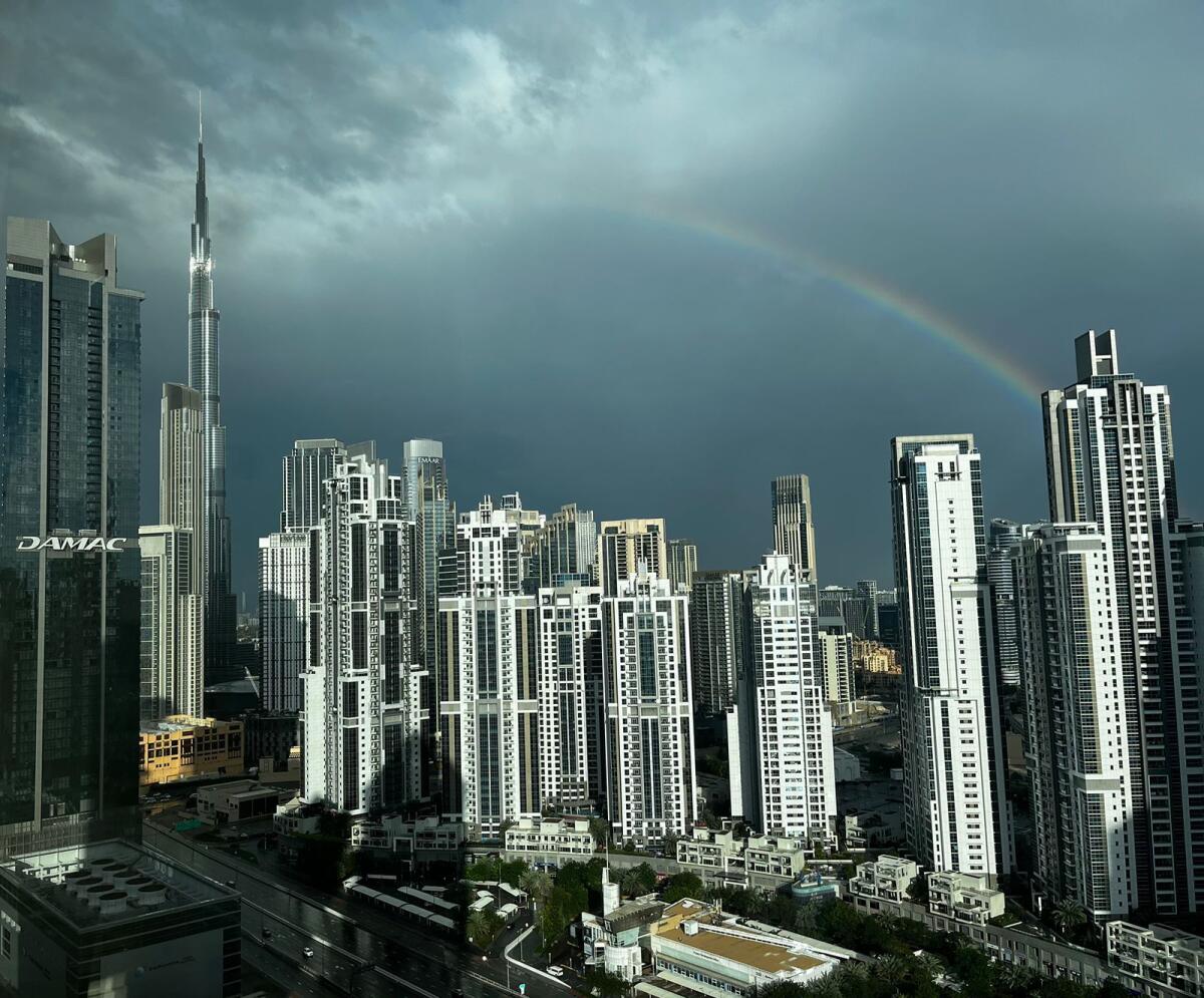 Al Batha resident Arnav Chandanani's captivating photo reveals a rainbow gracefully arching over Executive Towers, with the iconic Burj Khalifa standing tall in the background as the rains subside.