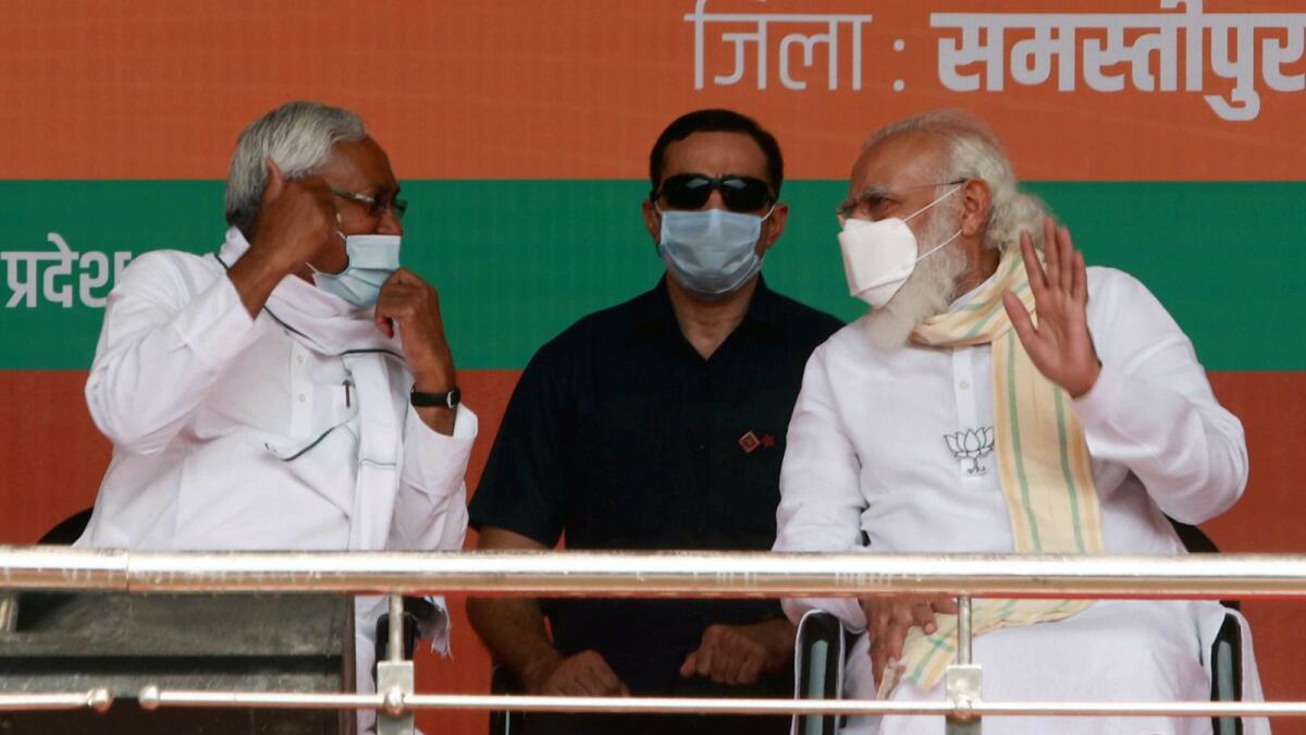 Prime Minister Narendra Modi and Bihar Chief Minister Nitish Kumar in conversation during an election rally for the second phase of Bihar Assembly polls in Samastipur on Sunday.
