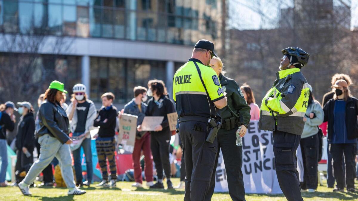 Police watch as pro-Palestinian protesters create a human chain around an encampment set up at Northeastern University in Boston. — AFP file