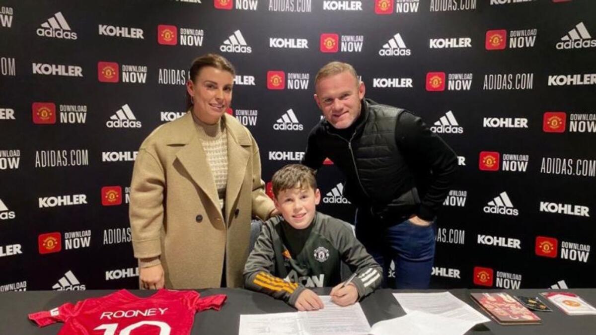 Kai Rooney, the oldest of Wayne Rooney's four sons, signing a contract to join Man United's youth academy. (Wayne Rooney's Twitter)