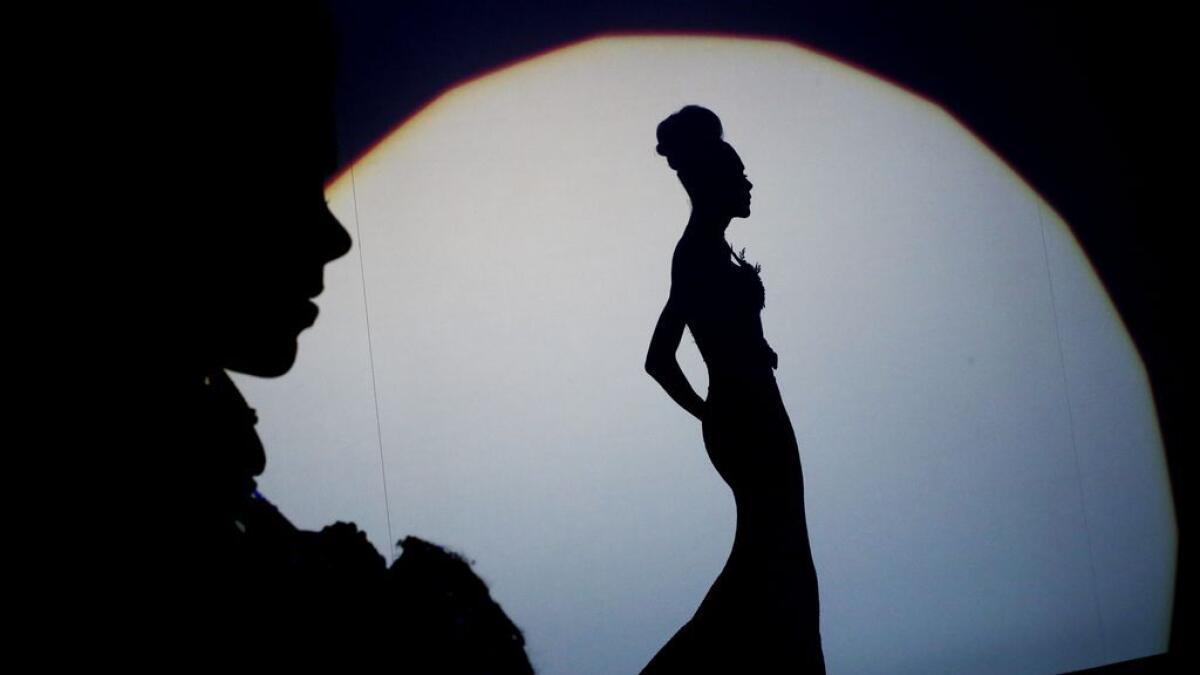 A participant poses on the stage during the Miss Trans Star International beauty pageant in Cornella de Llobregat.-AFP 