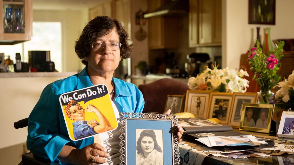 Dorene Giacopini holds up a photo of her mother Primetta Giacopini at her home in Richmond, California on Sept 27, 2021.