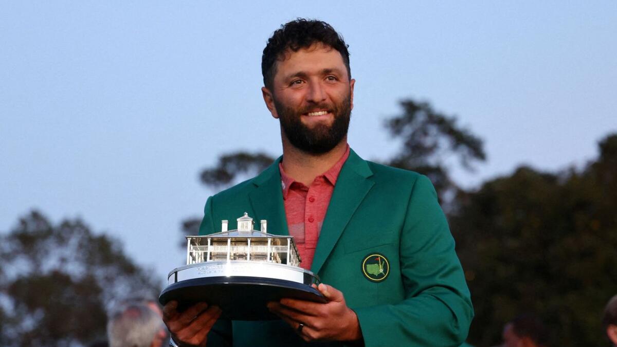 Spain's Jon Rahm celebrates with his green jacket and the trophy after winning The Masters in 2013. - Reuters File