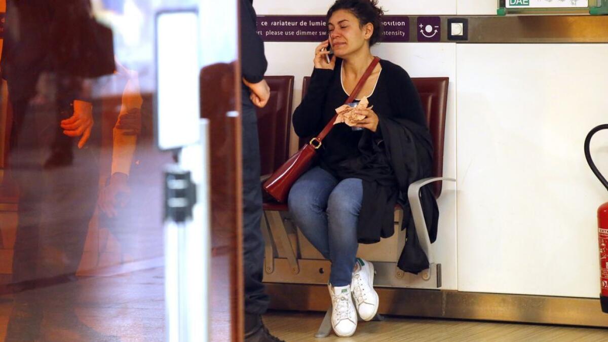 A relative of the victims of the EgyptAir flight 804 that crashed, reacts as she makes a phone call at Charles de Gaulle Airport outside of Paris.