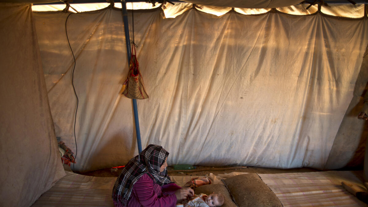 Naela Mohammed with her four-month-old daughter Asmahan inside her tent.