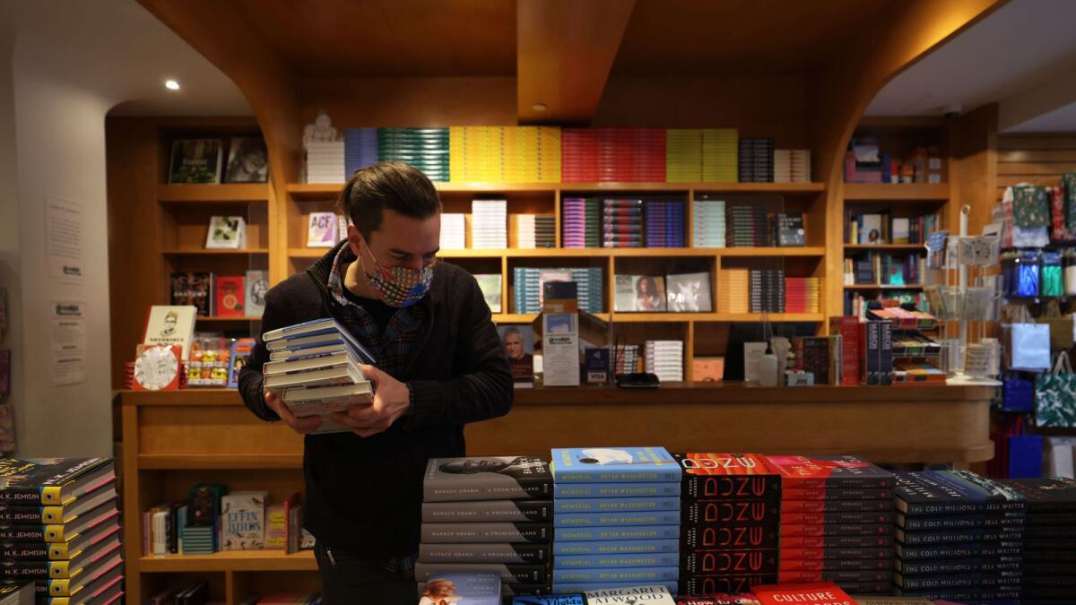 Niko Tsocanos makes room for former President Barack Obama's memoir at the Greenlight Bookstore in the Flatbush neighbourhood of Brooklyn on November 17, 2020 in New York City.
