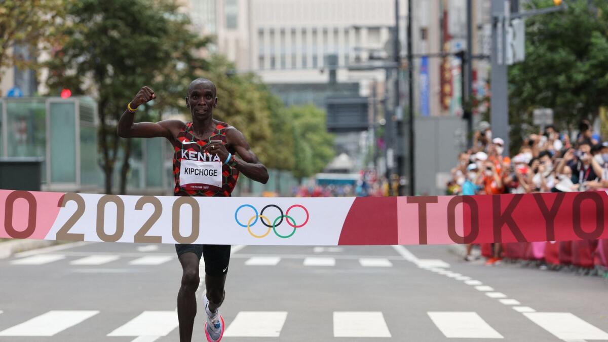 Kenya's Eliud Kipchoge crosses the finish line to win the men's marathon final during the Tokyo 2020 Olympic Games in Sapporo. — AFP