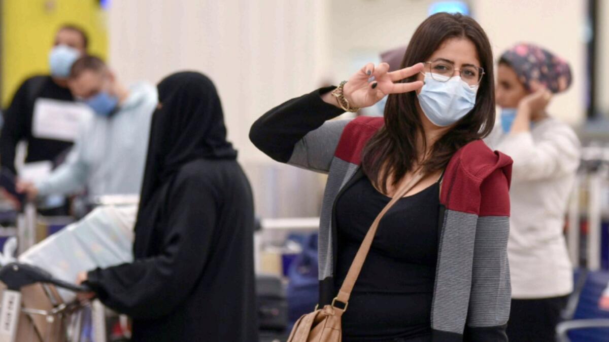 Passengers arrive at Dubai airport- — AFP file