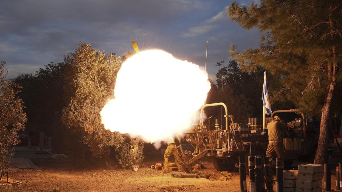 Israeli soldiers fire mortars from southern Israel towards the Gaza Strip. — AP