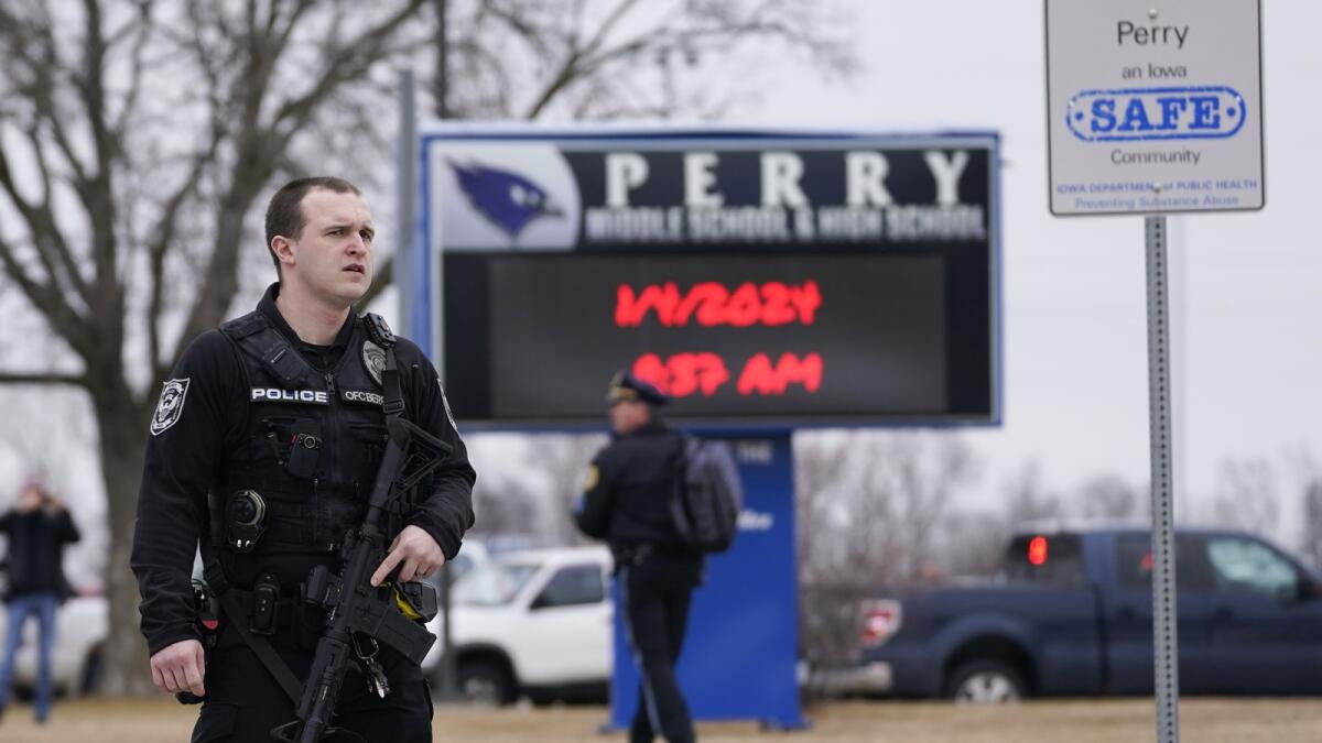 Police respond to Perry High School in Perry, Iowa. — AP