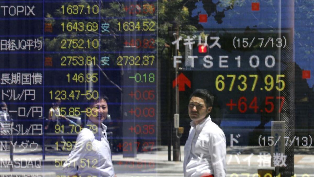 A man checks on stock prices at a brokerage house in Beijing.