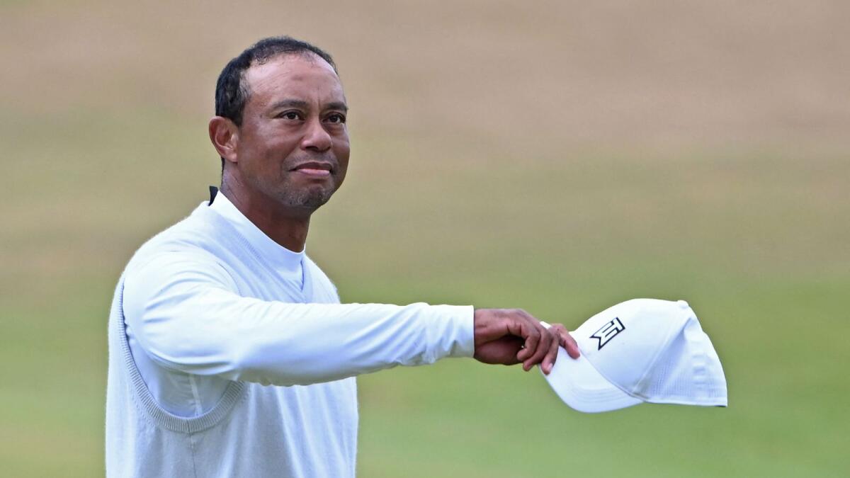 Tiger Woods gestures to the crowd on the 18th green at the end of his second round at St Andrews on Friday. — AFP