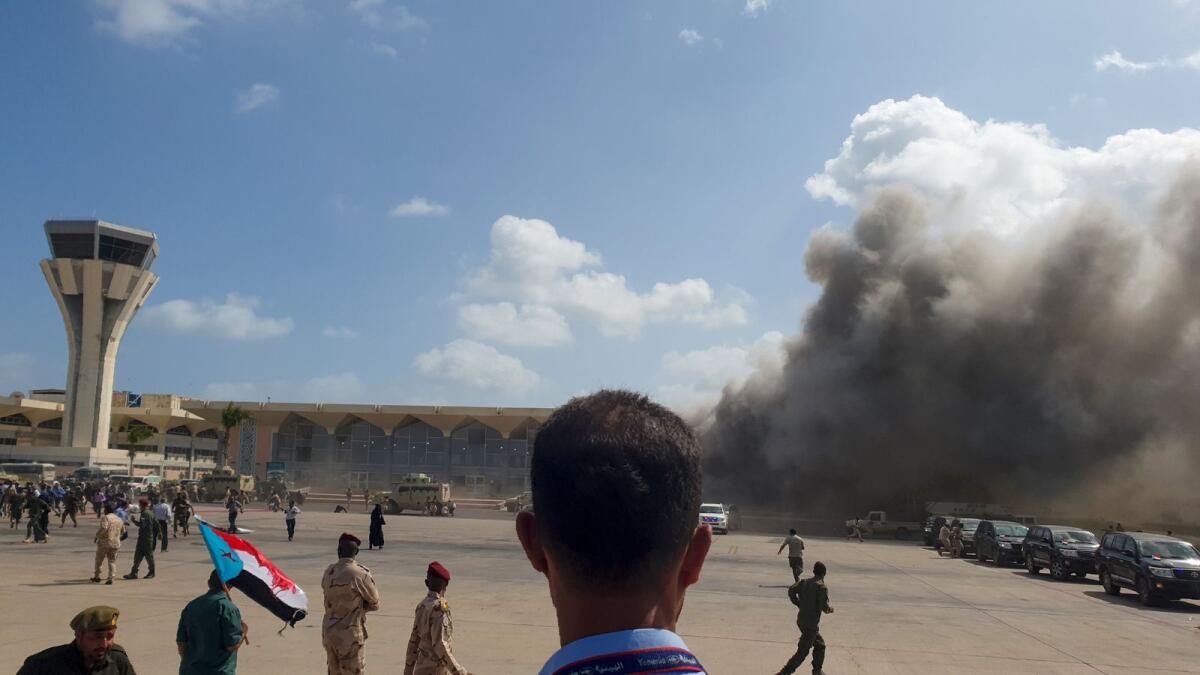 Smoke billows after explosions rocked the Aden Airport shortly after the arrival of a plane carrying members of a new unity government.