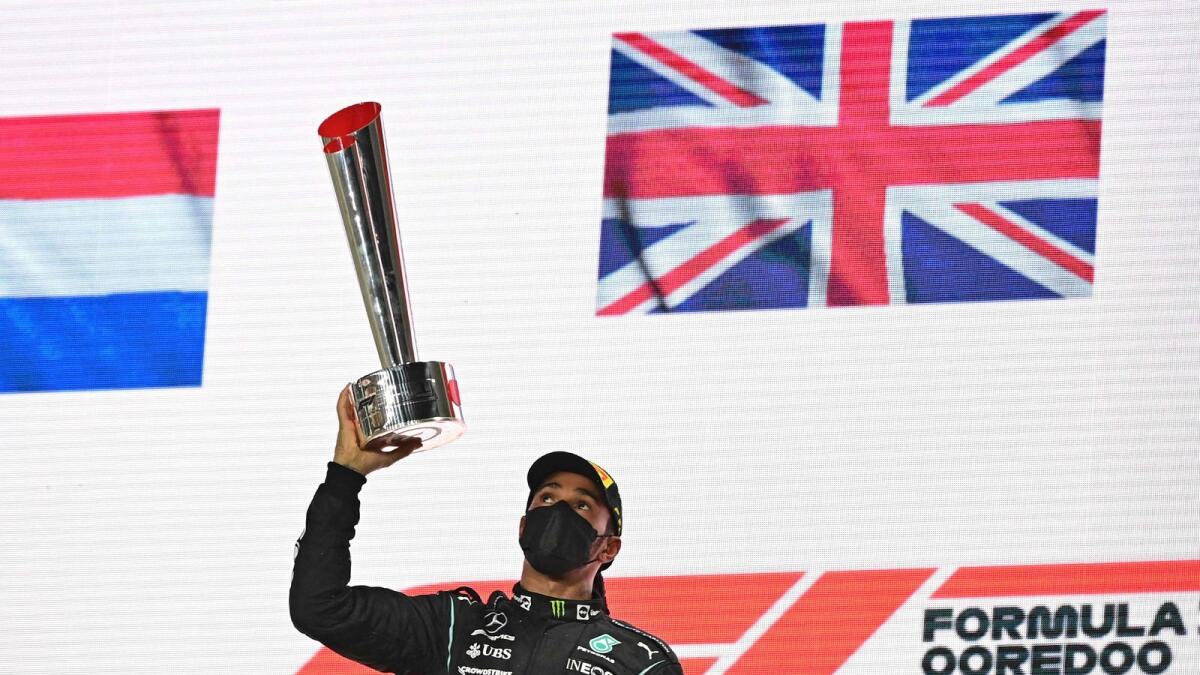 Mercedes' British driver Lewis Hamilton celebrates with his trophy. (AFP)