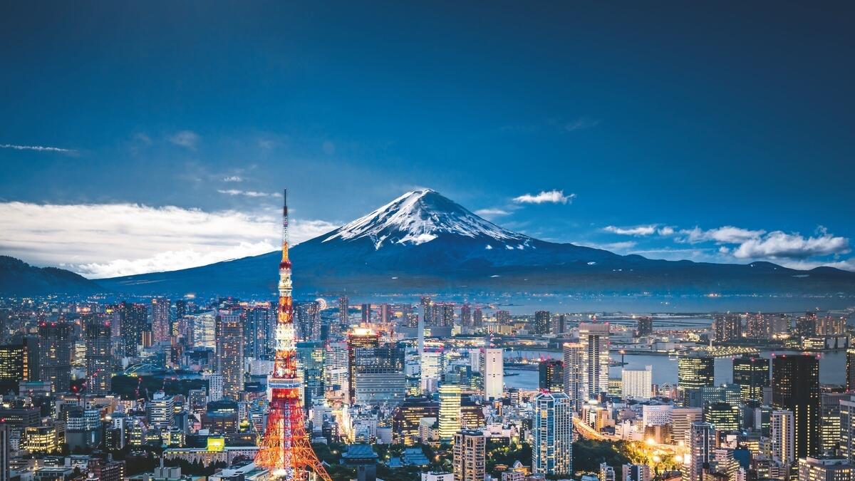 A panoramic view of central Tokyo and the snow-capped Mount Fuji.