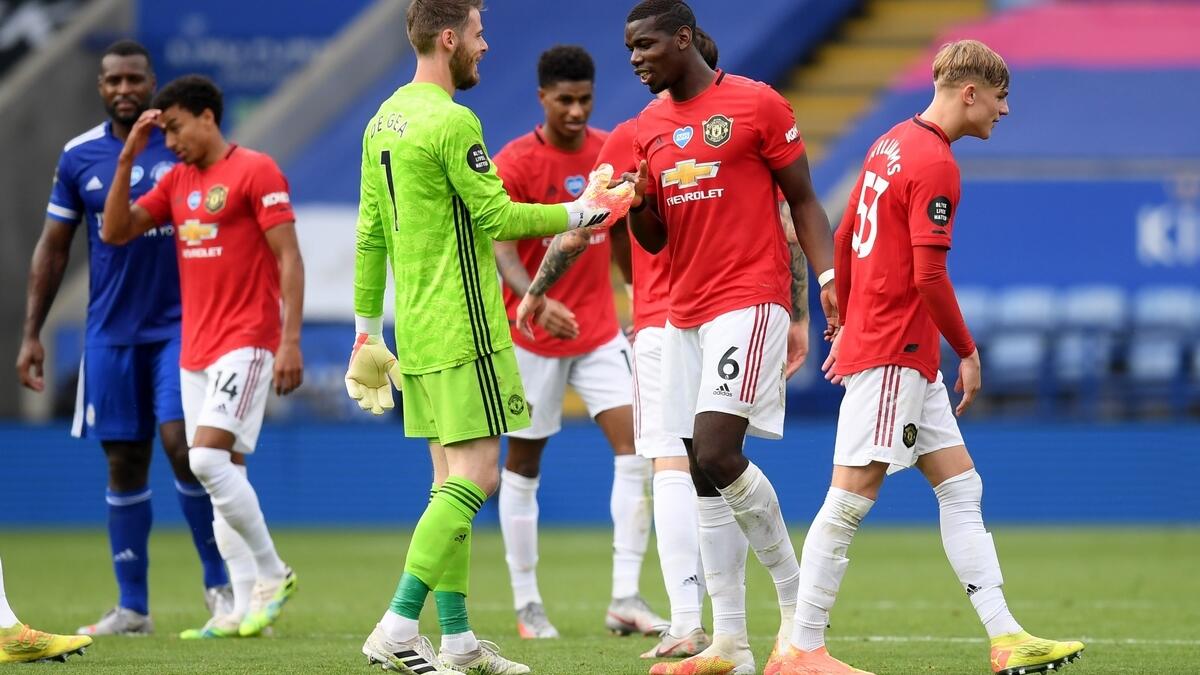 Manchester United held their nerves on a final-day shootout for a place in the top four, winning 2-0 at Leicester