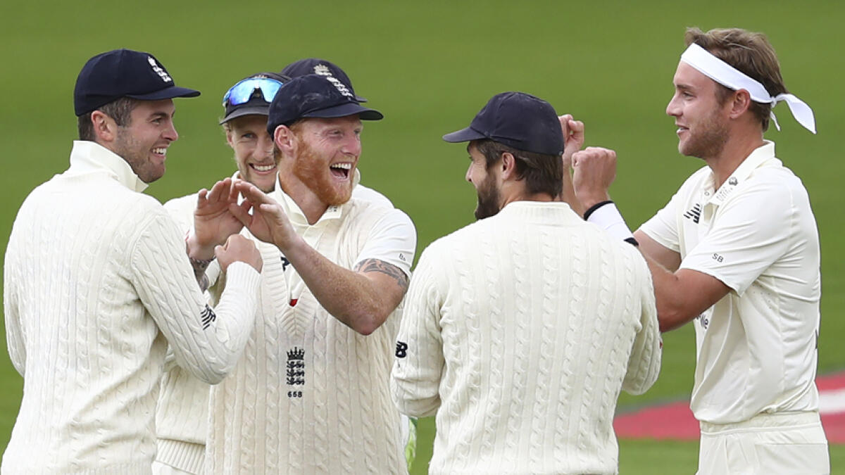 England's Stuart Broad (right) and teammates celebrate the dismissal of West Indies' John Campbell during the final day of the second cricket Test. - AP